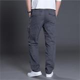 Men's gray cargo pants with multiple pockets, worn with white sneakers and a white shirt