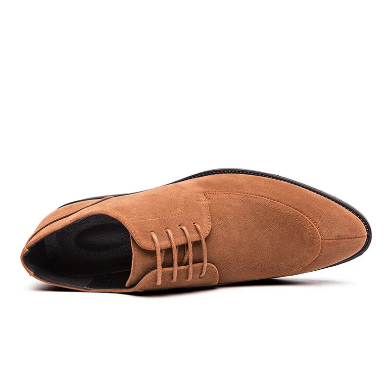 tan suede men's dress shoe with pointed toe and lace-up detail on white background