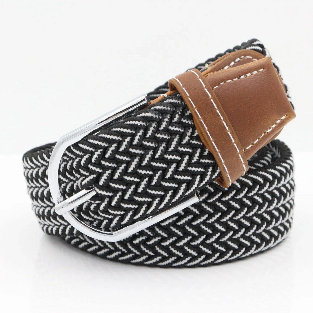 Black and white woven fabric belt with silver buckle and brown leather accents on white background