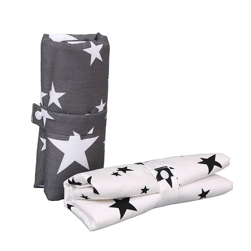 Folded reusable shopping bags with white star patterns on black and white backgrounds