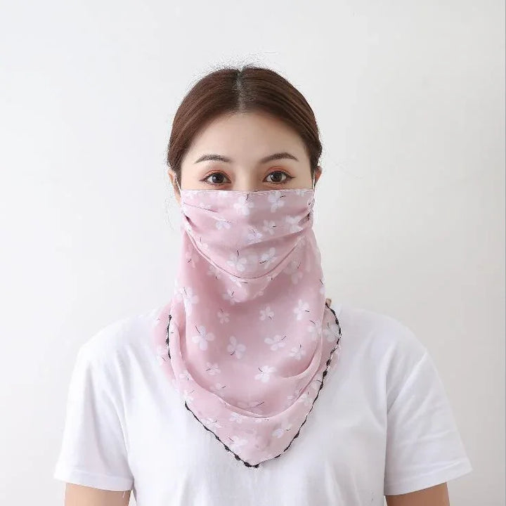 Woman wearing a pink floral face scarf covering nose and mouth, paired with a white t-shirt