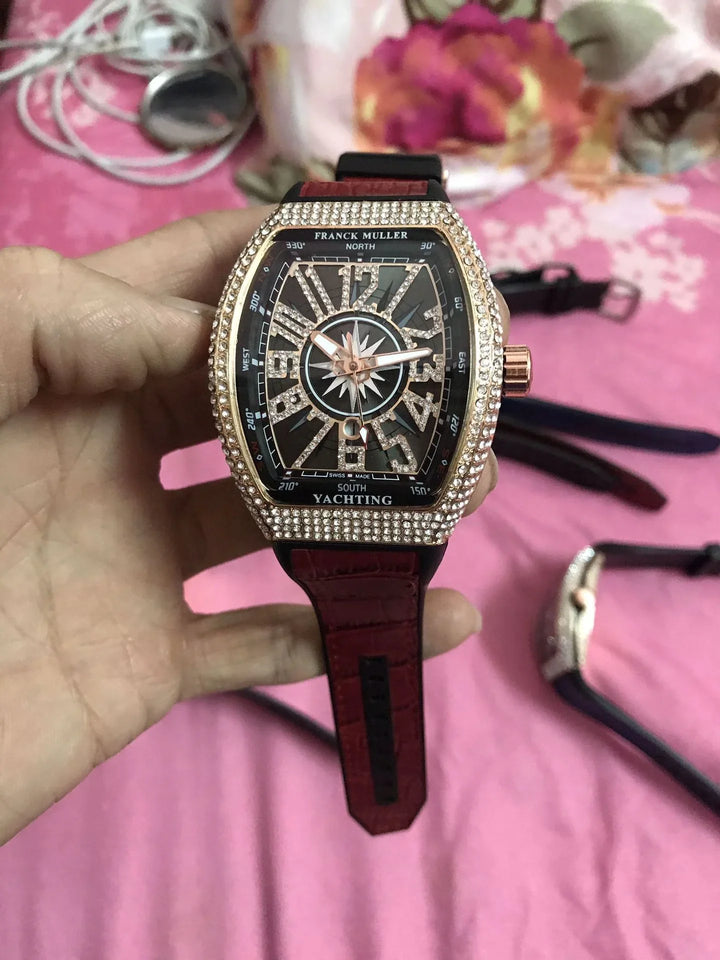 Franck Muller Yachting wristwatch with diamond-studded bezel and red leather strap held over pink floral fabric