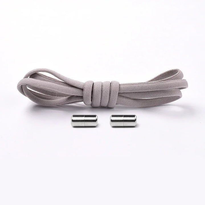 Gray elastic no tie shoelace with two silver magnetic shoelace locks on white background
