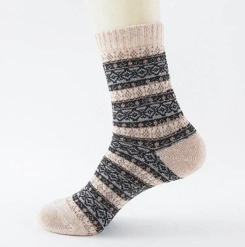 Beige socks with black and gray geometric patterns on a white mannequin foot