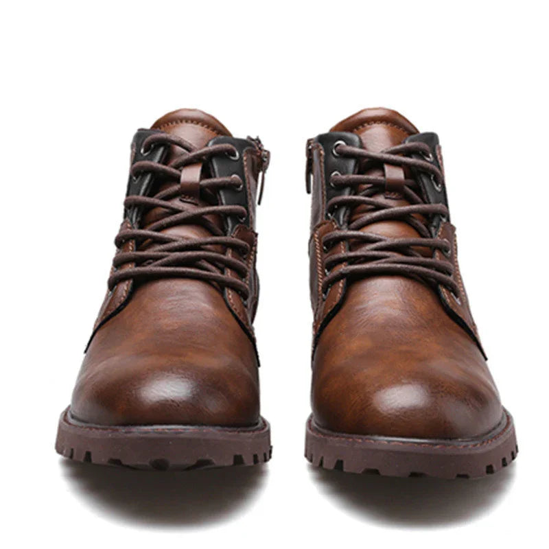 Pair of brown leather lace-up boots with side zippers and rugged soles on white background