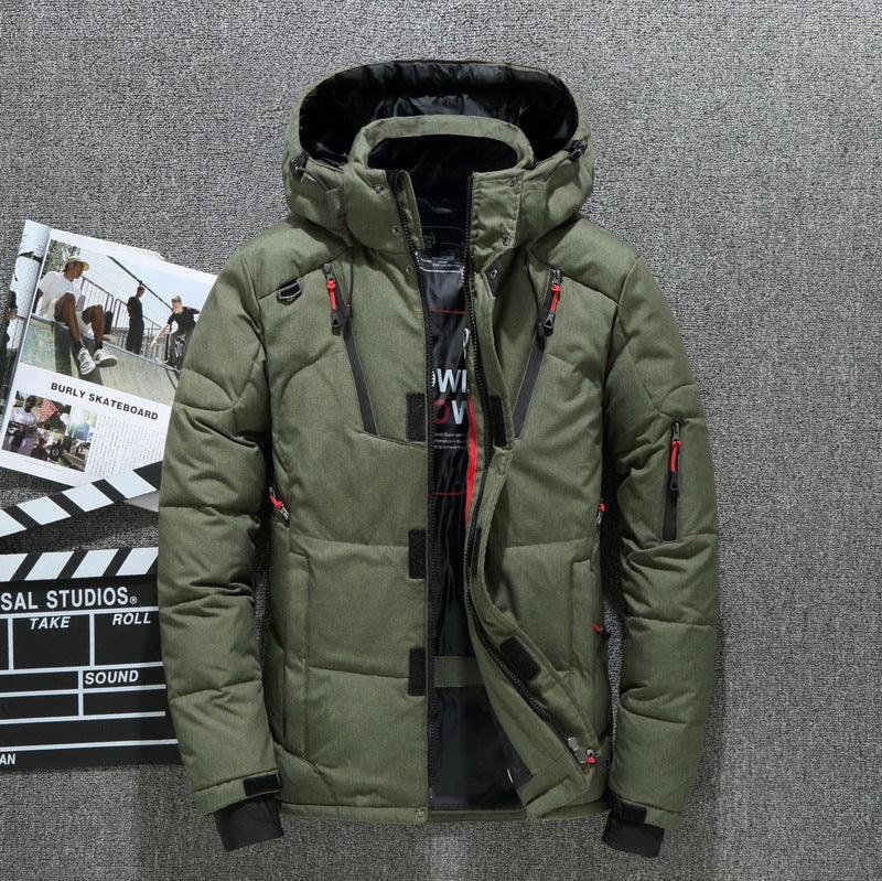 olive green insulated winter jacket with hood and red zipper accents on gray surface