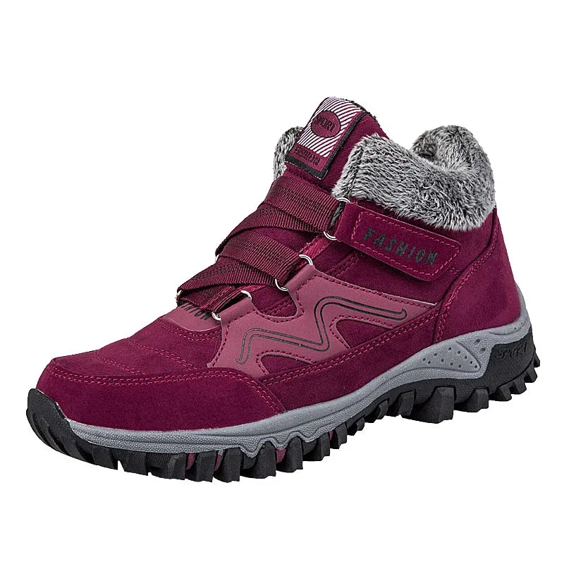 Maroon winter hiking boot with grey fur lining, rugged black sole, and fashion strap detail
