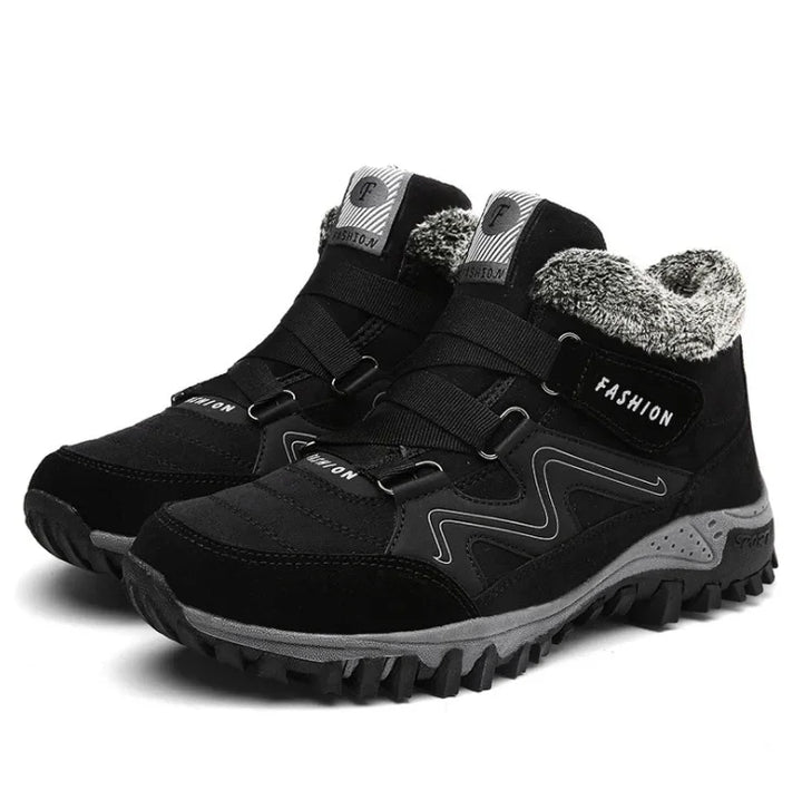 Black winter hiking boots with gray fur lining, rugged soles, and fashion branding on sides