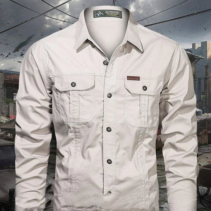 Men's outdoor long-sleeve beige shirt with button pockets and collar under cloudy sky