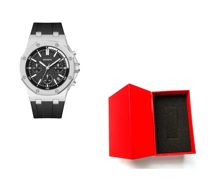 Silver wristwatch with black dial and rubber strap alongside open red watch box with black foam insert