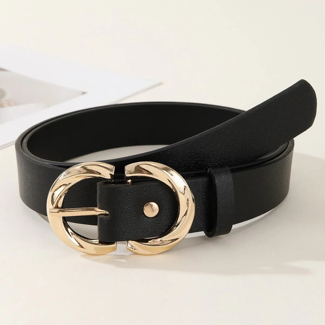 Black leather belt with shiny gold twisted oval buckle on white surface