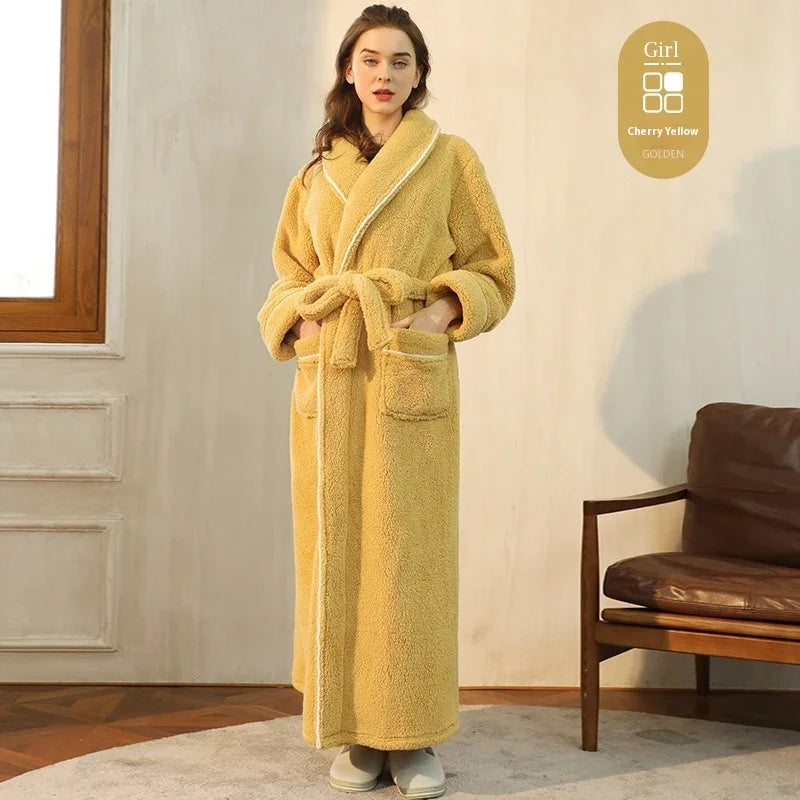 Woman in long cherry yellow cozy fleece bathrobe standing indoors near brown leather chair