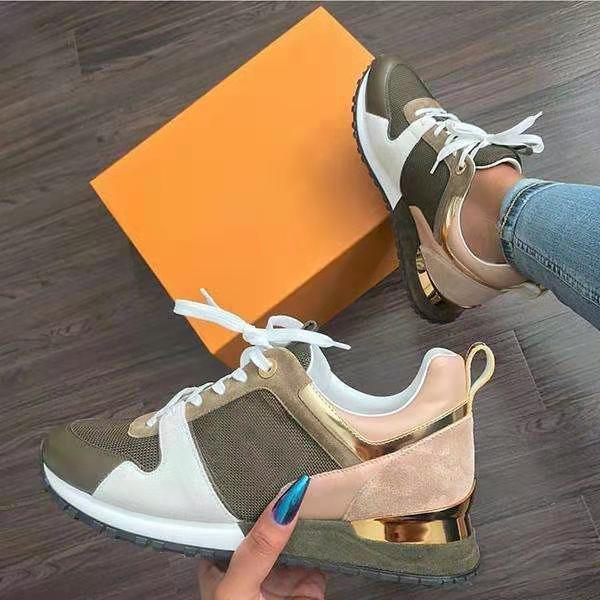 Stylish women's sneakers in olive, beige, and white with gold accents on wooden floor near orange shoebox