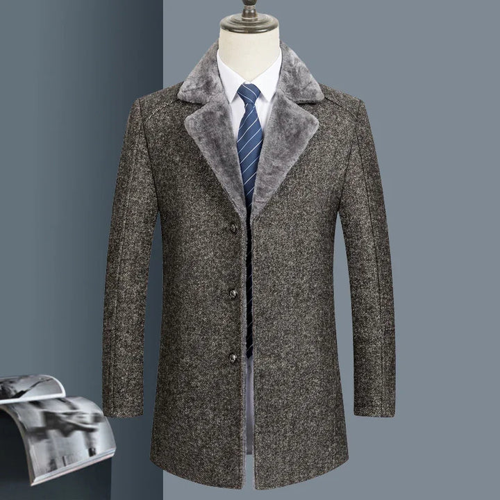 Men's grey wool coat with fur collar, white shirt, and blue striped tie on mannequin