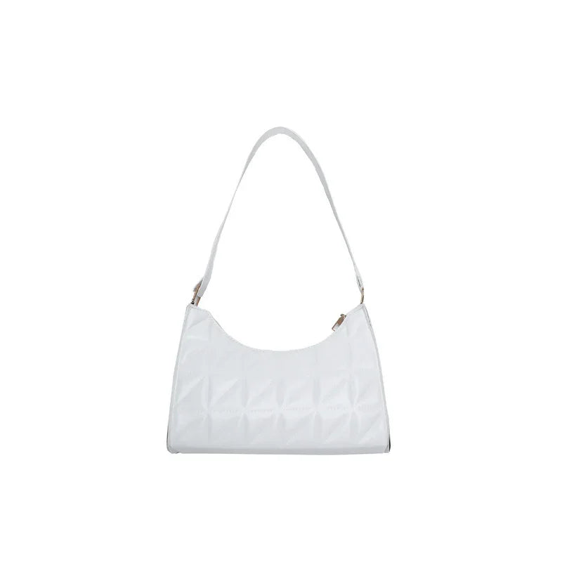white quilted shoulder bag with curved top and single strap isolated on white background