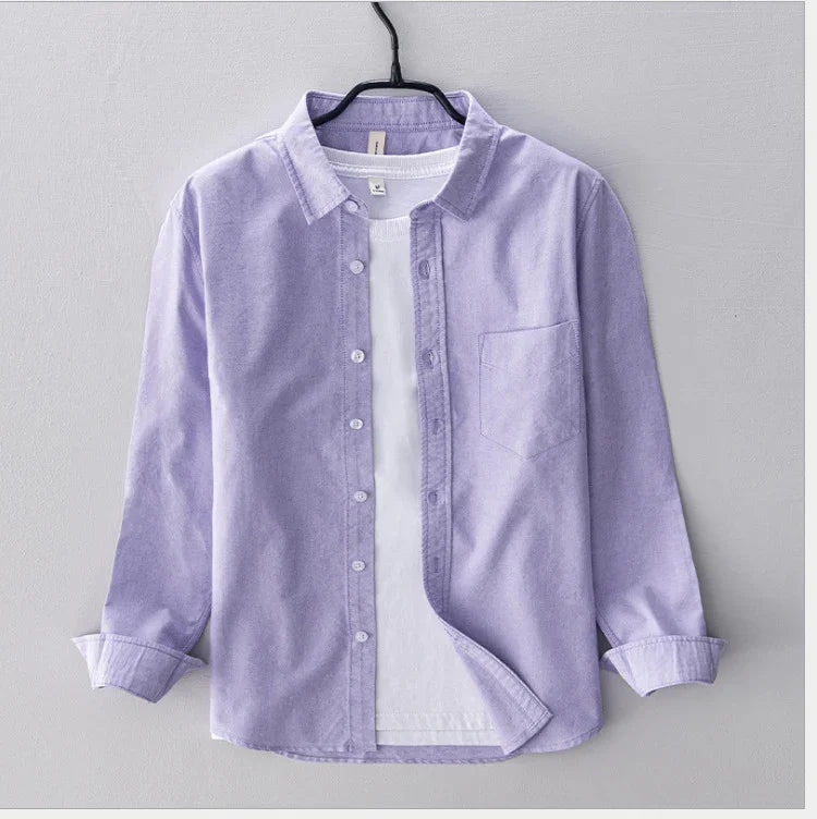 Light purple button-up shirt with front pocket layered over white t-shirt on black hanger
