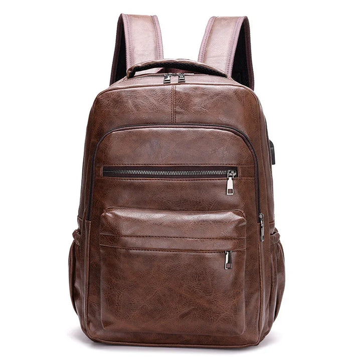 Brown leather backpack with multiple zippered pockets and padded shoulder straps