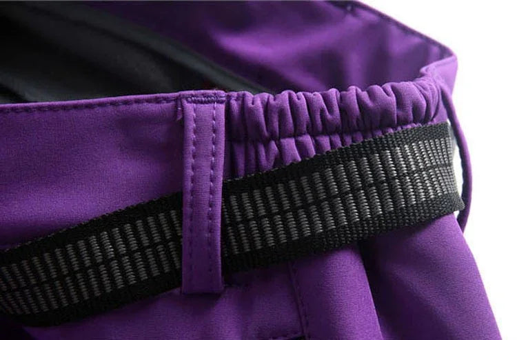 Close-up of purple pants waistband with black elastic belt and belt loop detail