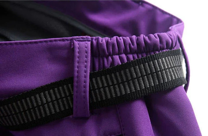 Close-up of purple pants waistband with black elastic belt and belt loop detail