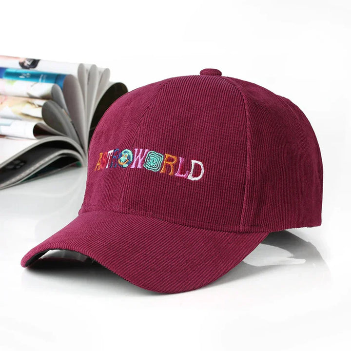Burgundy corduroy cap with colorful embroidered Astroworld text on white background