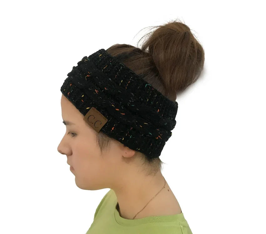 Profile of woman wearing black knitted headband with CC logo and casual green top
