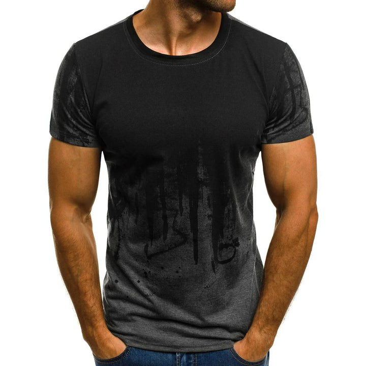 Man wearing black and dark gray short-sleeve t-shirt with abstract dripped design, hands in pockets