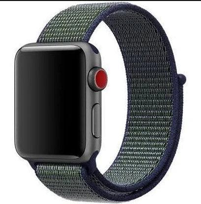 Smartwatch with a dark gray case and black screen, featuring a textured green and blue woven nylon band