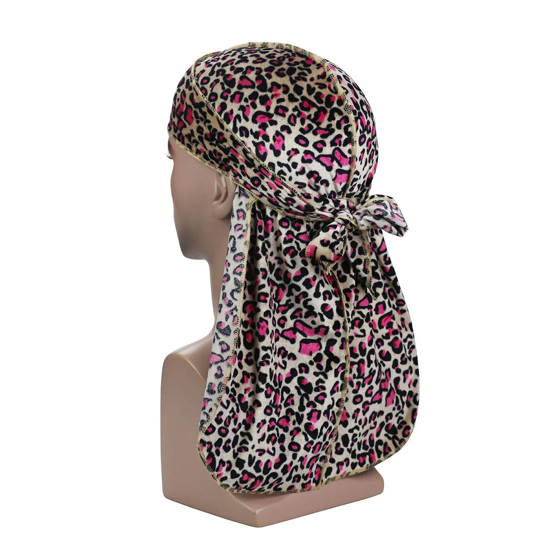 Mannequin head wearing pink and black leopard print durag with tied knot at back