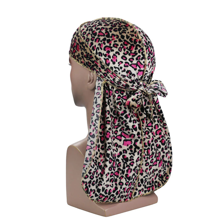 Mannequin head wearing leopard print durag with pink accents tied at back