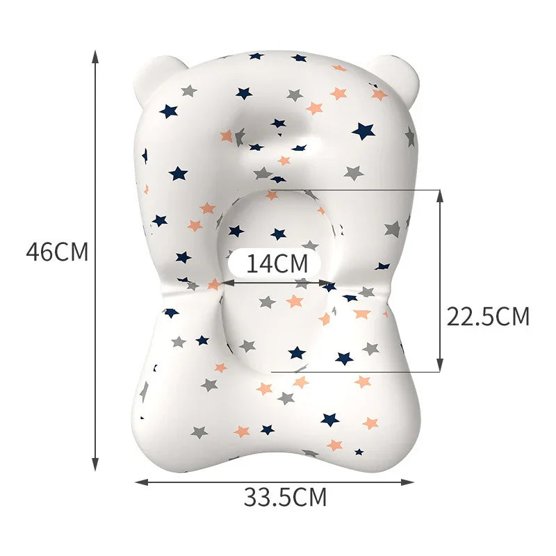 White baby pillow with colorful star patterns and measurements for head and body support