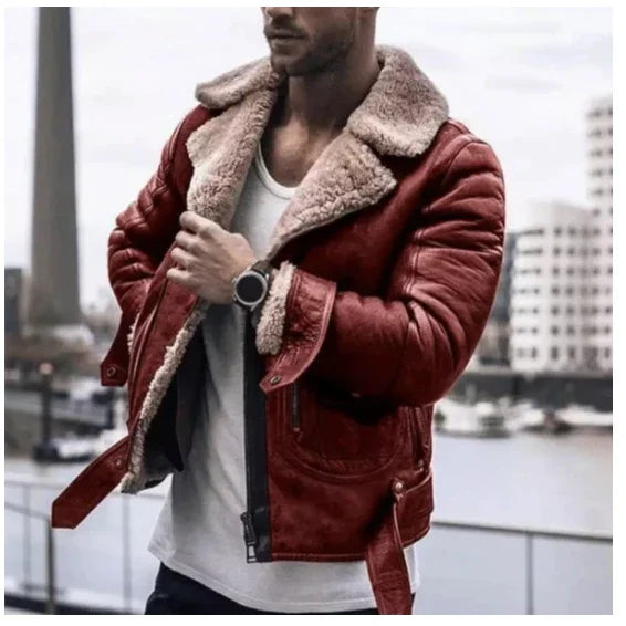 Man wearing red leather shearling jacket over white shirt standing by urban waterfront with buildings