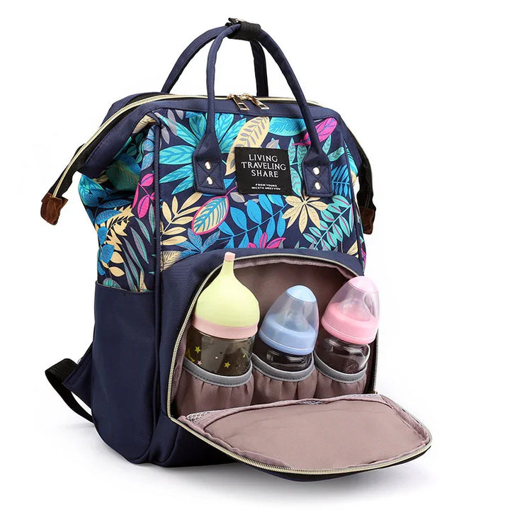 Colorful floral diaper backpack with separate front compartment holding three baby bottles