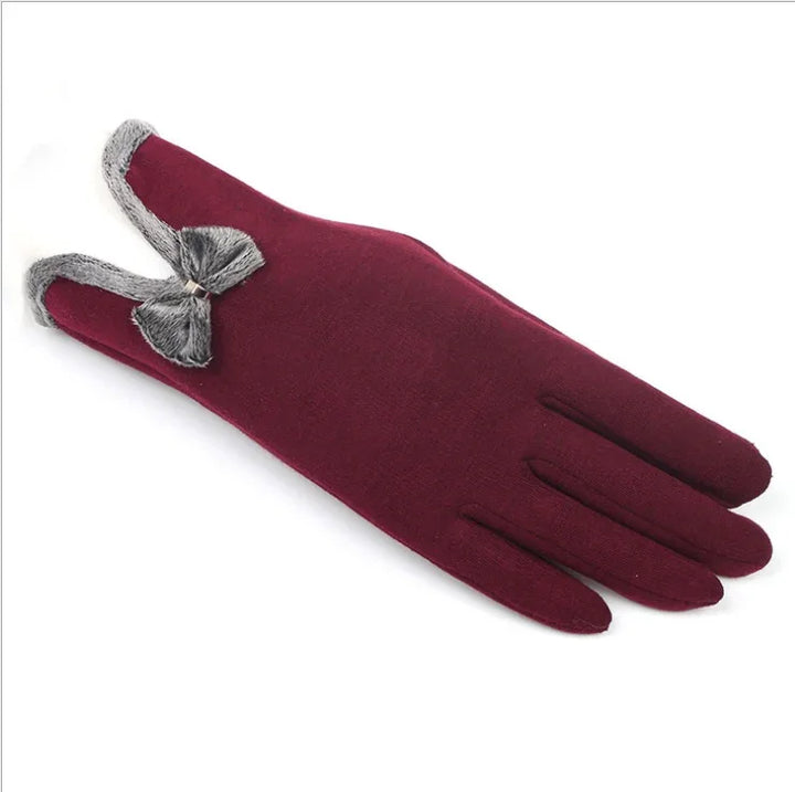 Elegant burgundy winter glove with gray faux fur trim and bow detail on white background