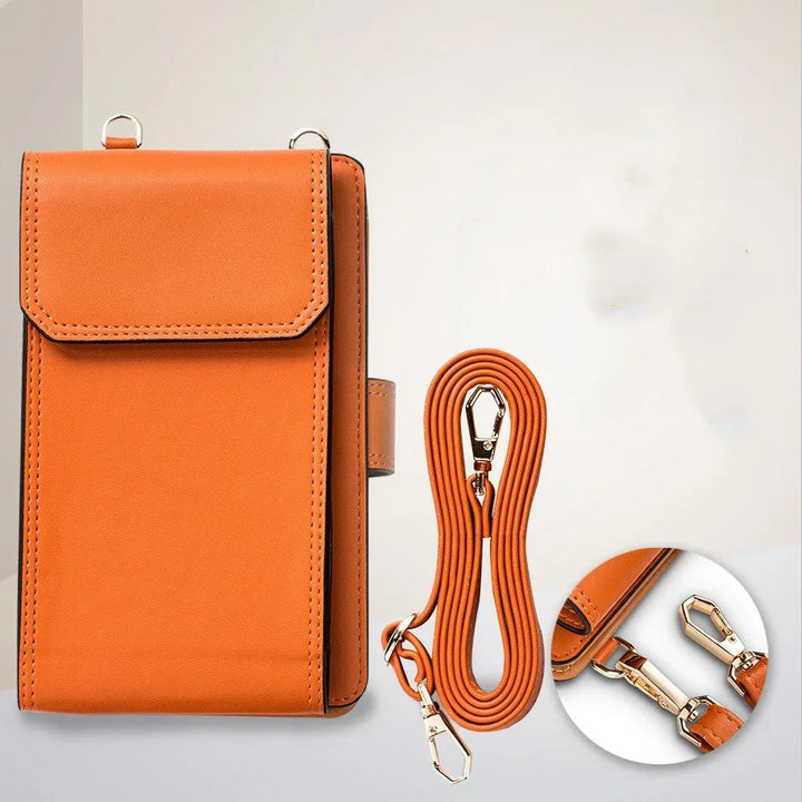 Orange leather crossbody bag with detachable strap and gold clips on white background
