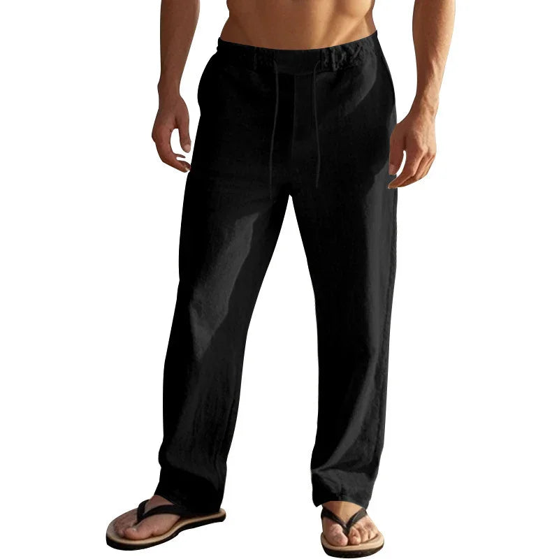 Man wearing black casual linen pants with drawstring and brown sandals, cropped torso view
