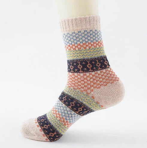Colorful knit sock with multi-patterned stripes on mannequin foot