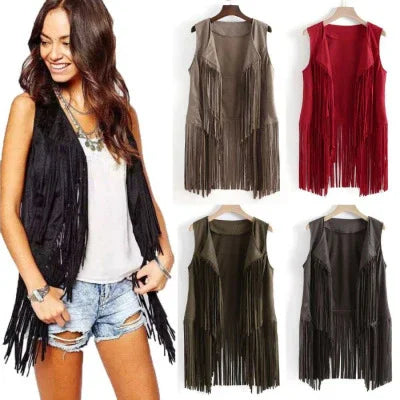 Woman wearing black fringe vest with white tank and ripped denim shorts, plus brown, red, green, and black fringe vests on hangers