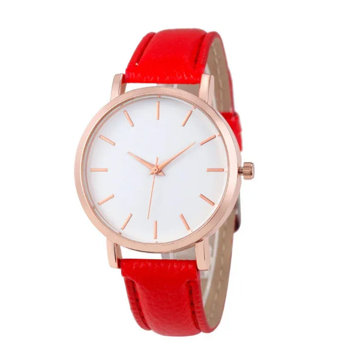 Minimalist wristwatch with white dial, rose gold case, and vibrant red leather strap