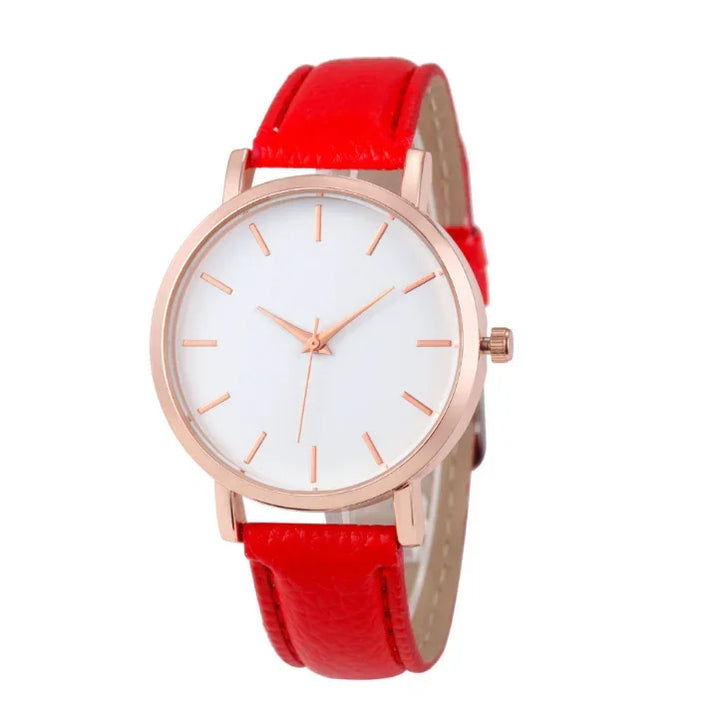 Minimalist wristwatch with white dial, rose gold case, and vibrant red leather strap