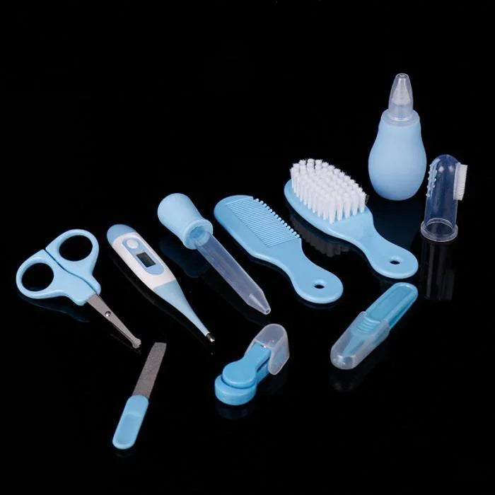 Blue and white baby grooming set with scissors, digital thermometer, comb, brush, nail clippers, nasal aspirator, and finger toothbrush on black background