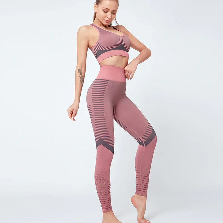 Woman wearing mauve and dark gray seamless high-waisted leggings and matching sports bra on white background