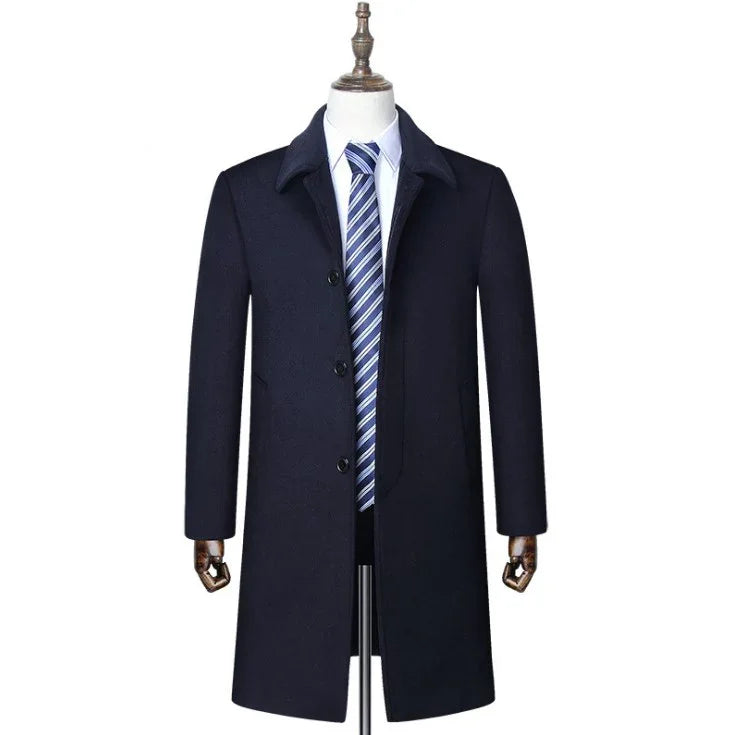 men's navy blue formal overcoat with black buttons on mannequin with white shirt and blue striped tie