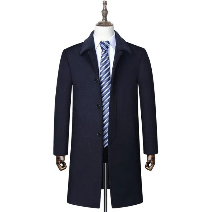 men's navy blue formal overcoat with black buttons on mannequin with white shirt and blue striped tie