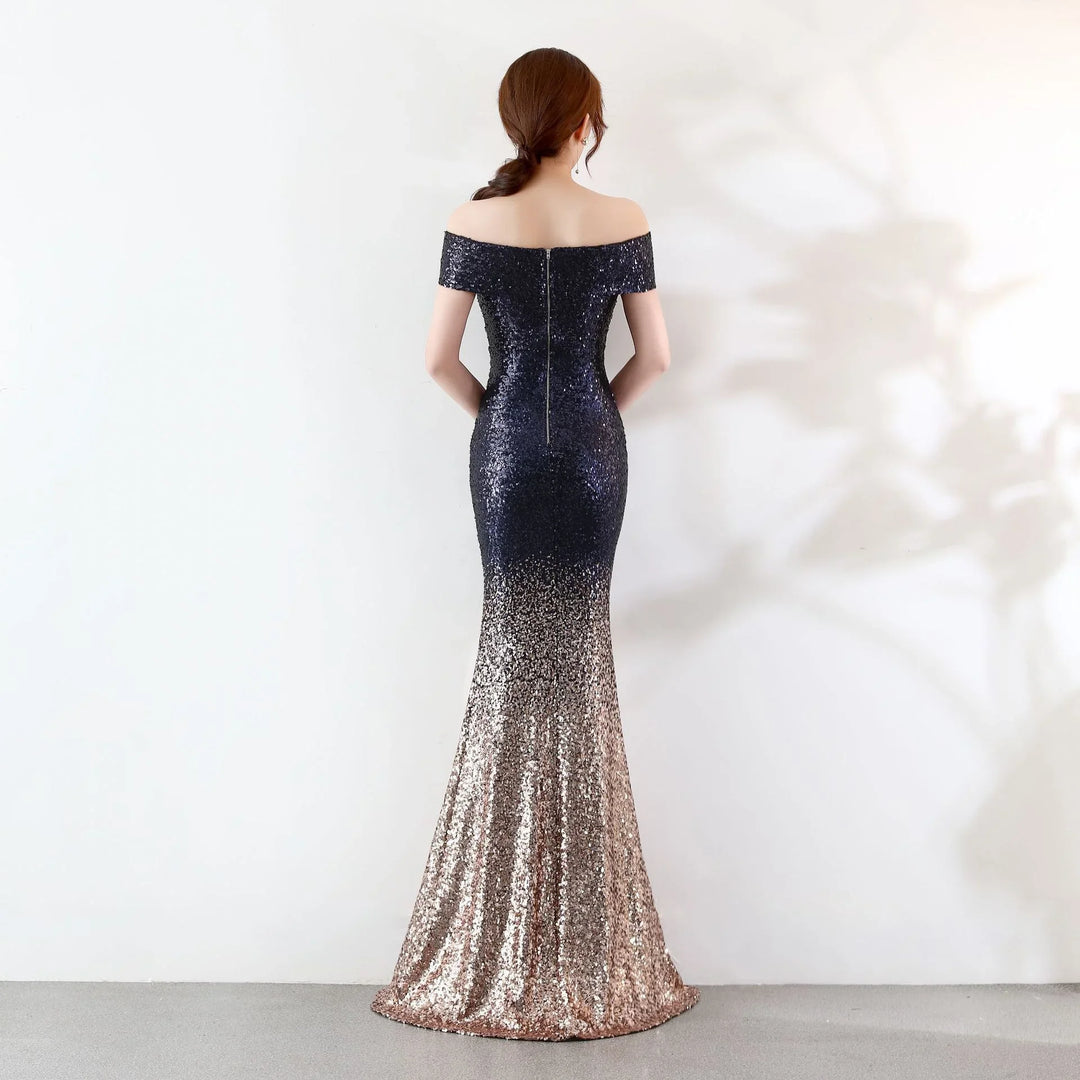 Woman in elegant off-shoulder sequin evening gown with ombre black to rose gold design
