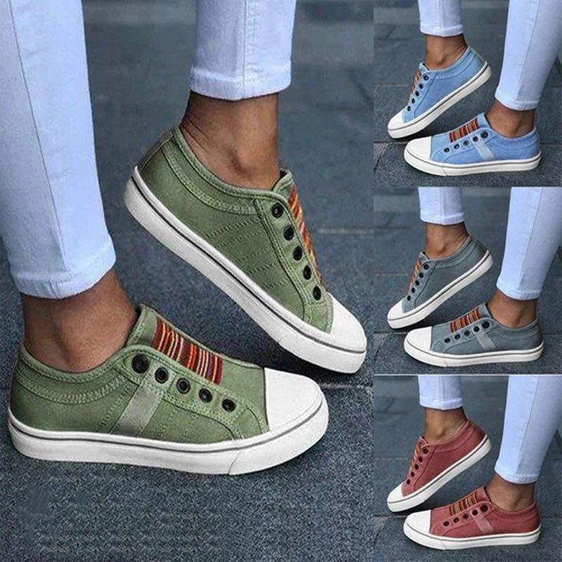 Casual canvas slip-on sneakers in green, blue, gray, and rust colors with white soles and striped elastic tongue details