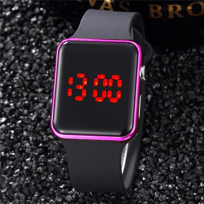 Black digital smartwatch with red LED time display and pink frame on textured black surface