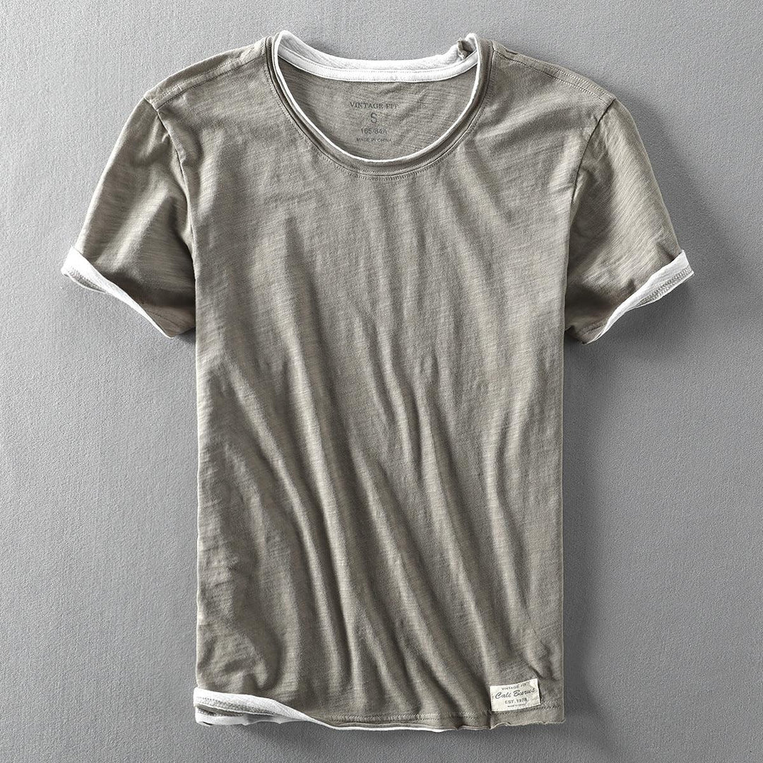 Gray vintage-fit short sleeve t-shirt with white trim on collar and cuffs on gray background