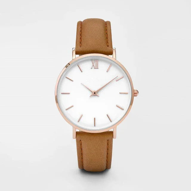 Minimalist wristwatch with brown leather strap and rose gold case on white background