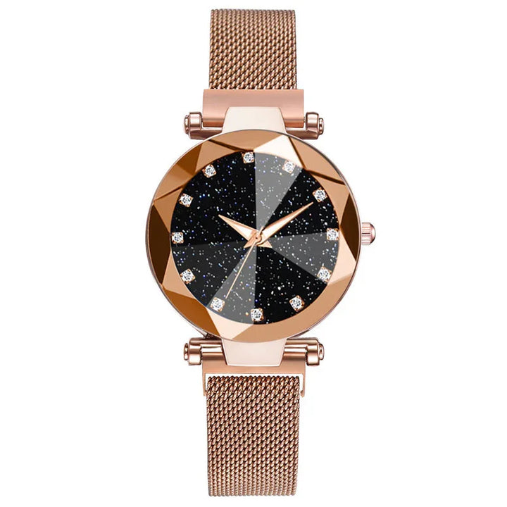 Rose gold mesh band watch with faceted black starry dial and crystal hour markers