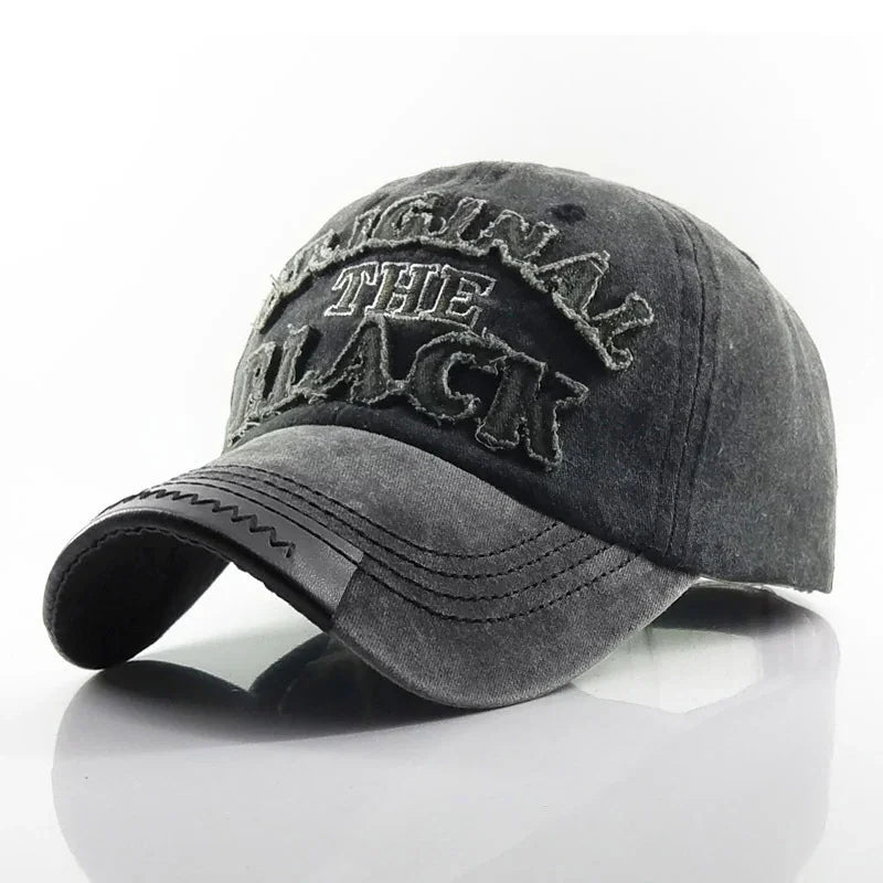 Grey distressed baseball cap with frayed embroidered letters spelling "ORIGINAL THE BLACK" on front